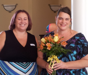 Michelle receiving colorful flowers from her friend Vanessa